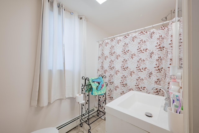 bathroom featuring sink and a baseboard heating unit