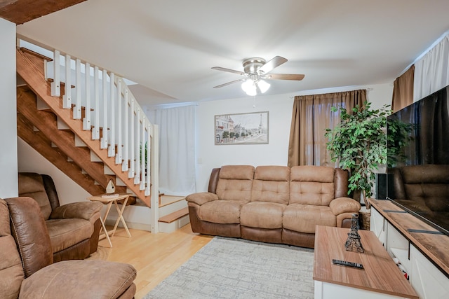 living room featuring light hardwood / wood-style floors and ceiling fan