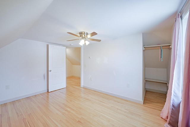 additional living space featuring ceiling fan, vaulted ceiling, and light wood-type flooring