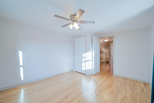 spare room with light hardwood / wood-style flooring and ceiling fan