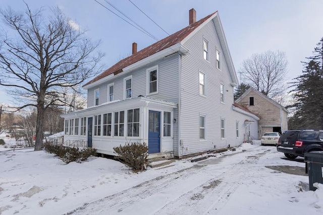 view of front of property featuring a sunroom