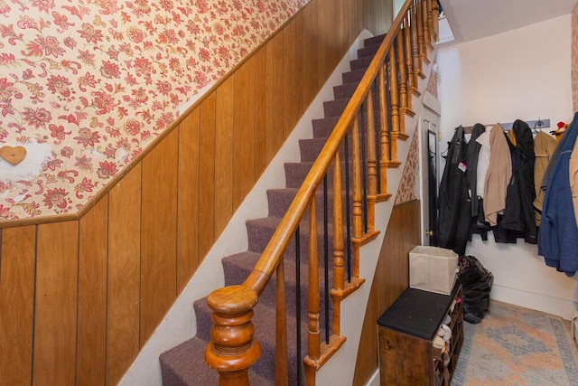 stairway with wood walls