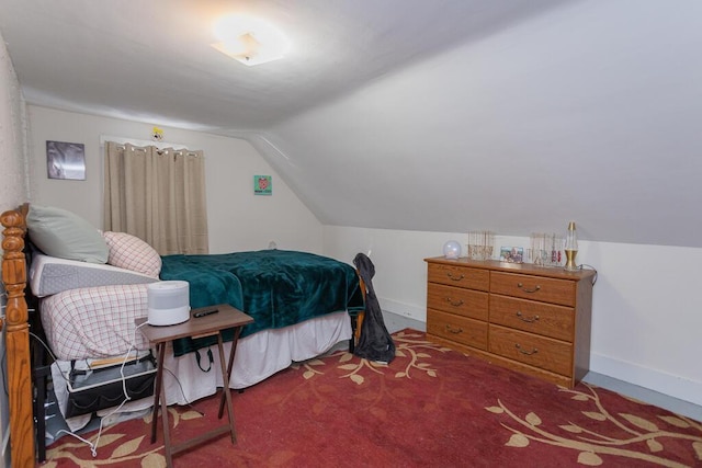 bedroom featuring lofted ceiling and carpet