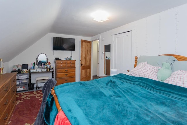 carpeted bedroom with lofted ceiling