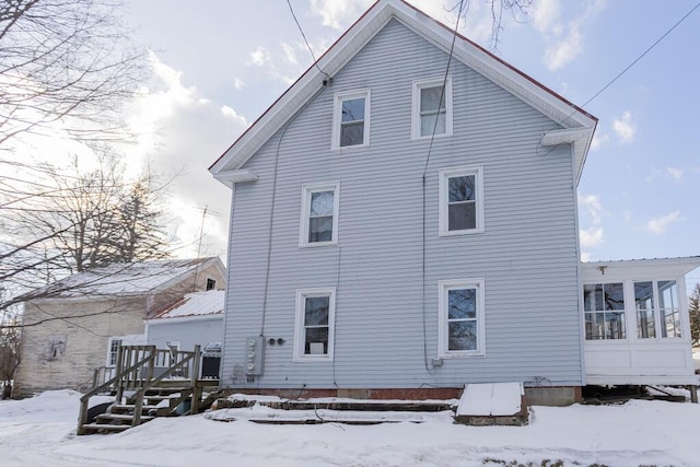 snow covered property featuring a wooden deck