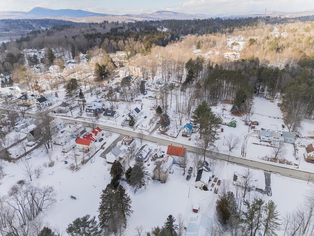 snowy aerial view featuring a mountain view