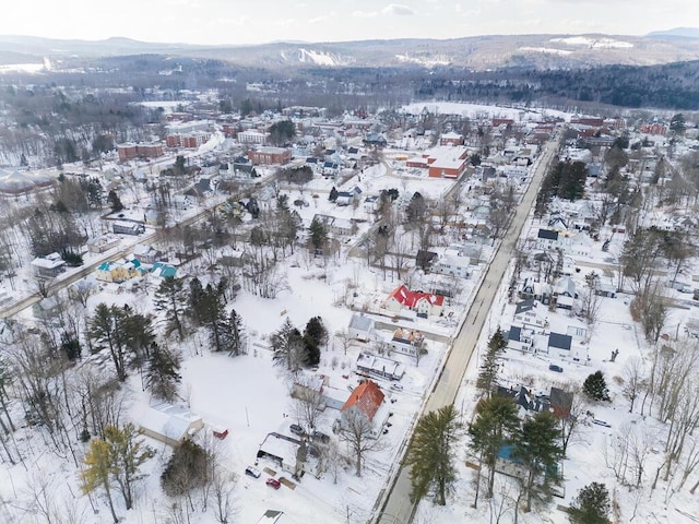 snowy aerial view featuring a mountain view