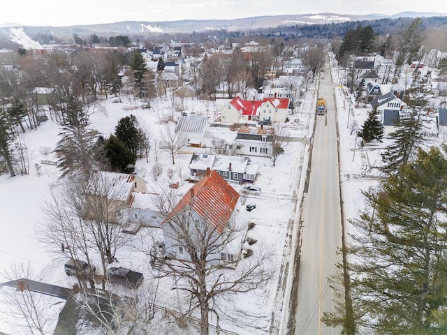 snowy aerial view with a mountain view