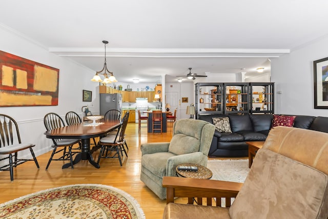 living room with crown molding, light hardwood / wood-style flooring, beamed ceiling, and ceiling fan with notable chandelier