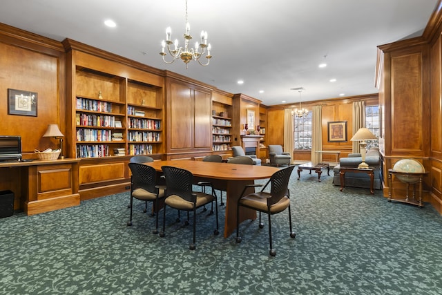 dining room with ornamental molding, dark carpet, built in features, and an inviting chandelier