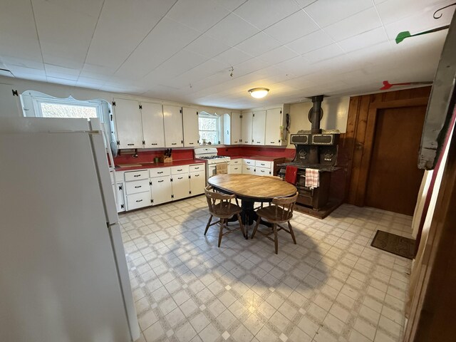 kitchen featuring white cabinets, white appliances, and a wealth of natural light