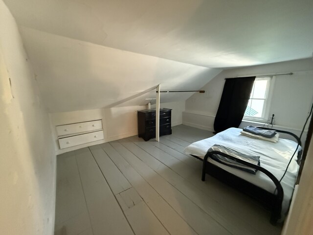 bedroom featuring vaulted ceiling and light hardwood / wood-style flooring