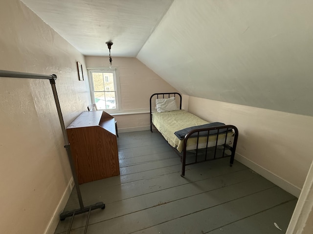 bedroom featuring lofted ceiling and wood-type flooring