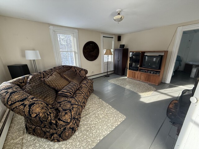 living room with concrete flooring and a baseboard heating unit