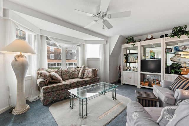 carpeted living room featuring a ceiling fan and baseboards