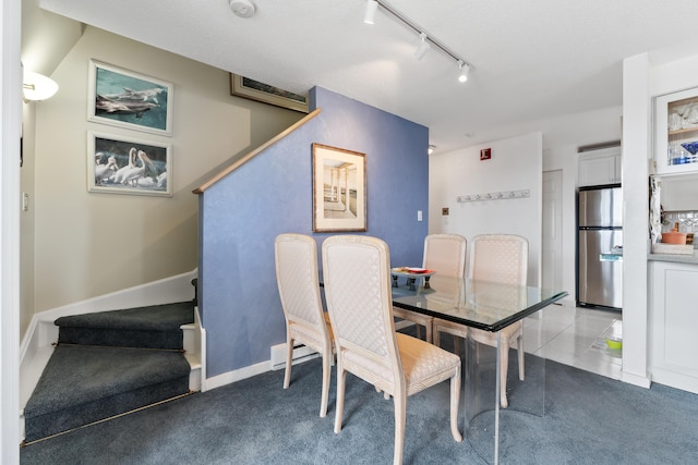 dining room featuring tile patterned floors, carpet flooring, and baseboards