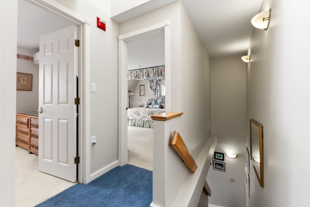 corridor with baseboards and carpet floors