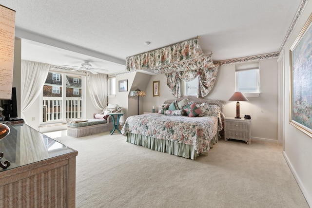 bedroom featuring a ceiling fan, baseboards, carpet floors, and a textured ceiling