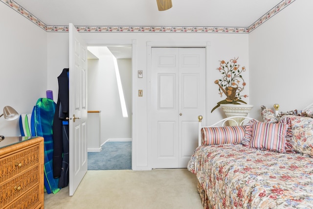 carpeted bedroom featuring a closet and ceiling fan