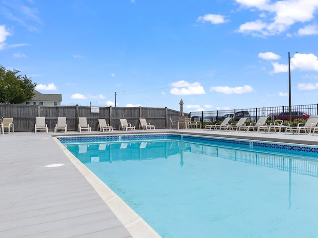 pool featuring a patio area and fence