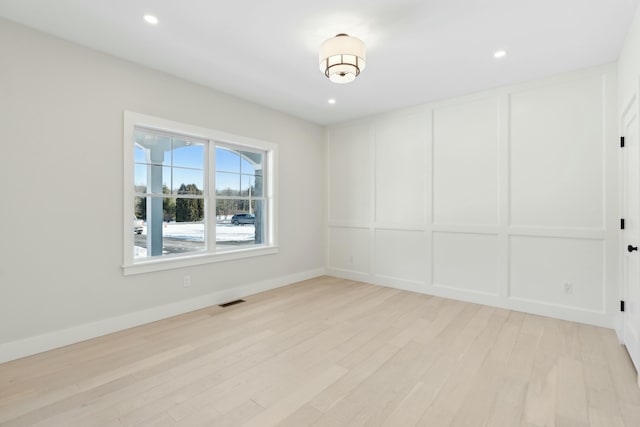 unfurnished room with light wood-type flooring