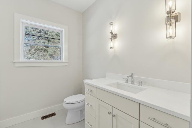 bathroom featuring tile patterned flooring, vanity, and toilet