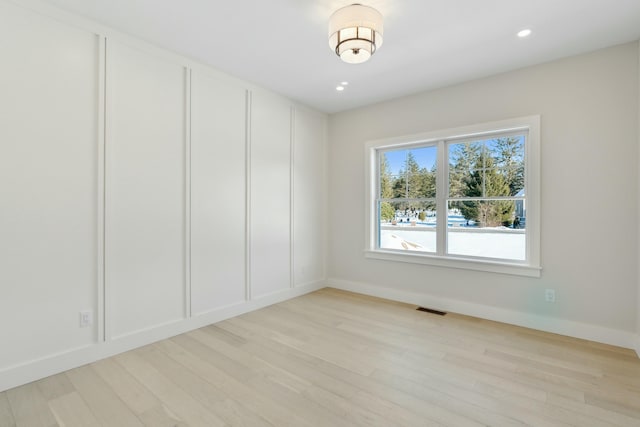 spare room featuring light wood-type flooring