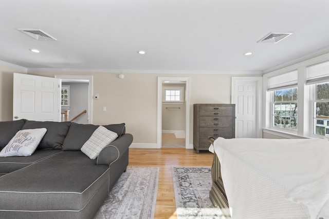 bedroom with crown molding and light hardwood / wood-style flooring