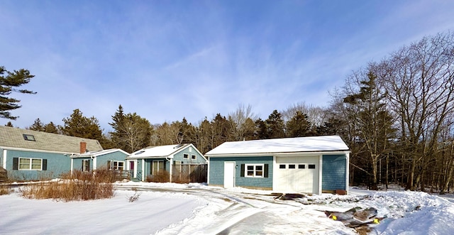 view of front of house featuring a garage and an outdoor structure