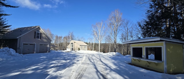 yard covered in snow with a garage