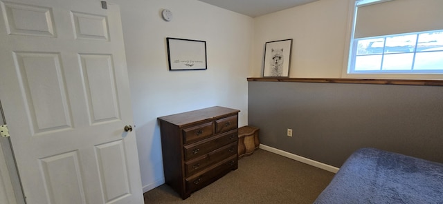 bedroom featuring dark colored carpet