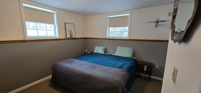 carpeted bedroom featuring multiple windows