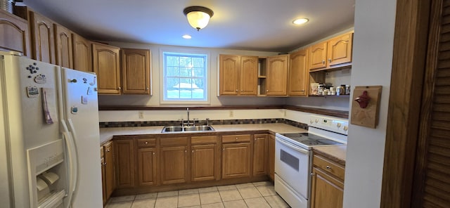 kitchen featuring sink, light tile patterned floors, and white appliances