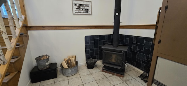 interior space with tile patterned flooring and a wood stove