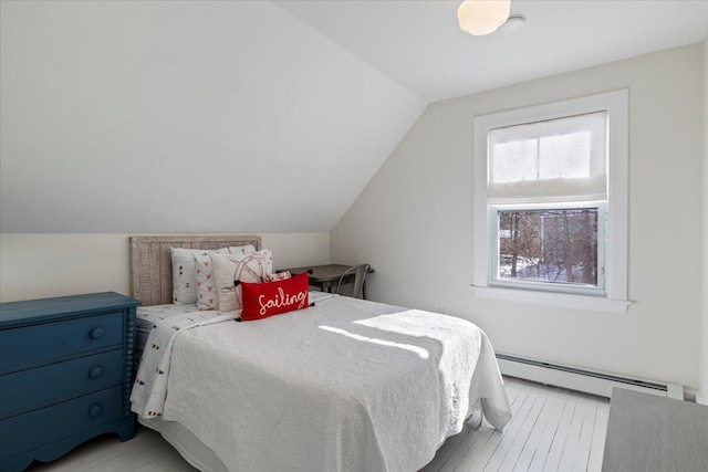 bedroom featuring vaulted ceiling and baseboard heating