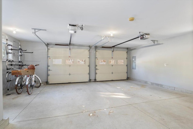 garage featuring a garage door opener and electric panel