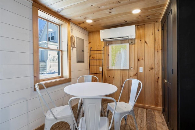 dining space with a wall mounted air conditioner, wooden walls, electric panel, wood ceiling, and a healthy amount of sunlight