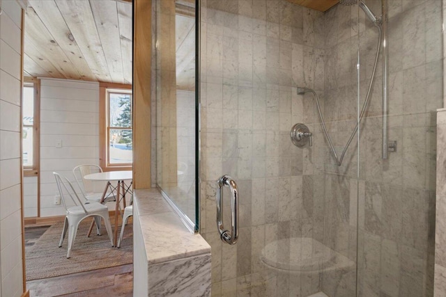 bathroom with a shower with door and wooden ceiling