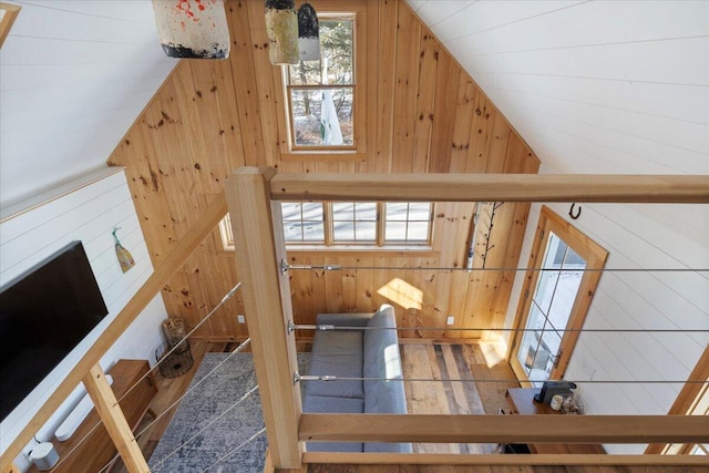 interior space with lofted ceiling and wooden walls