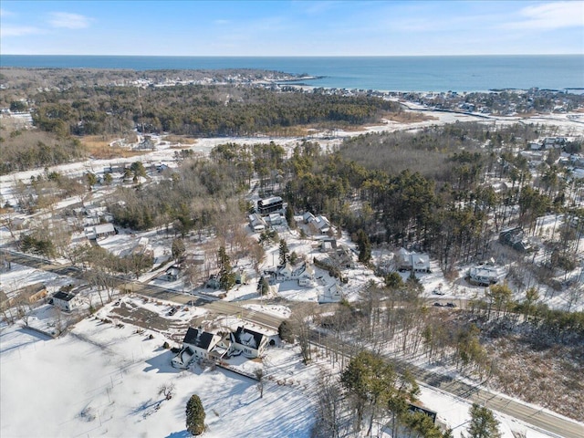 snowy aerial view with a water view