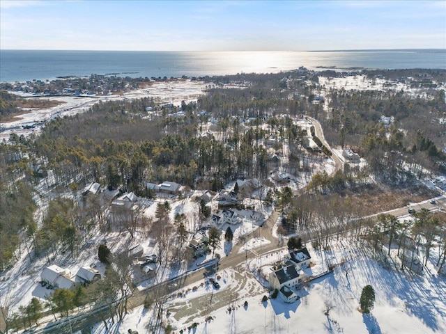 snowy aerial view featuring a water view