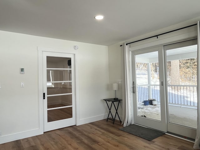 doorway with dark wood-type flooring