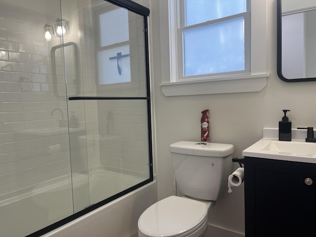 full bathroom with toilet, vanity, and shower / bath combination with glass door