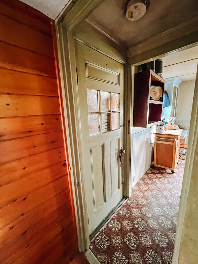 doorway featuring wood walls