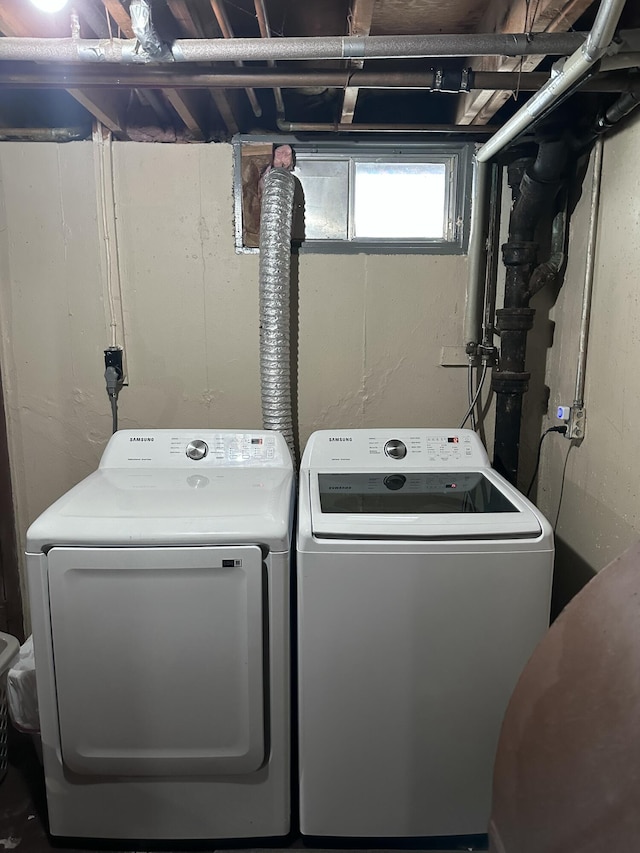 clothes washing area with washing machine and clothes dryer