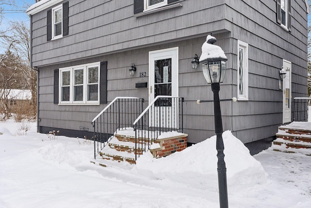 view of snow covered property entrance