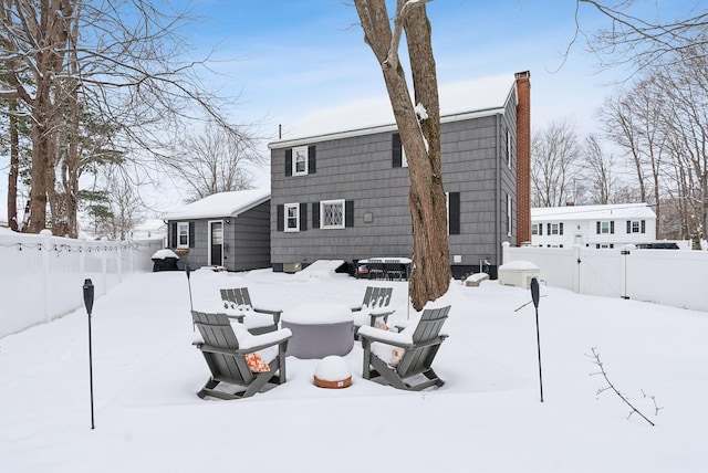 snow covered property featuring an outdoor fire pit