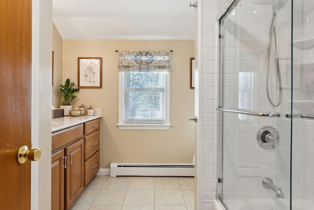 bathroom with an enclosed shower, vanity, a baseboard radiator, and tile patterned floors