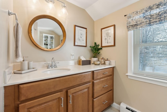 bathroom featuring lofted ceiling, vanity, and a baseboard heating unit