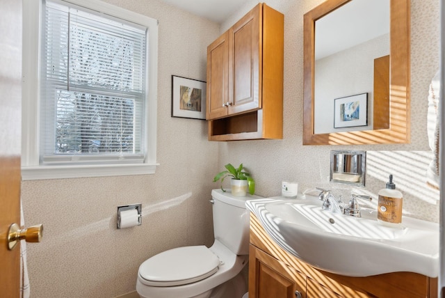 bathroom featuring vanity and toilet